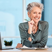 Woman smiling at a desk