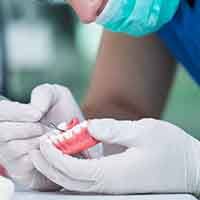 a dental lab technician constructing dentures